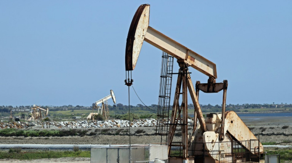 Stocks slide, oil holds gains on Middle East, economy concerns