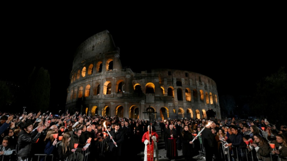 Pope leads torch-lit Colosseum procession before Easter